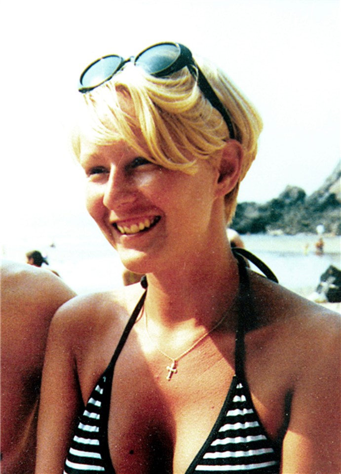 a woman wearing sunglasses and a bikini top smiles for the camera