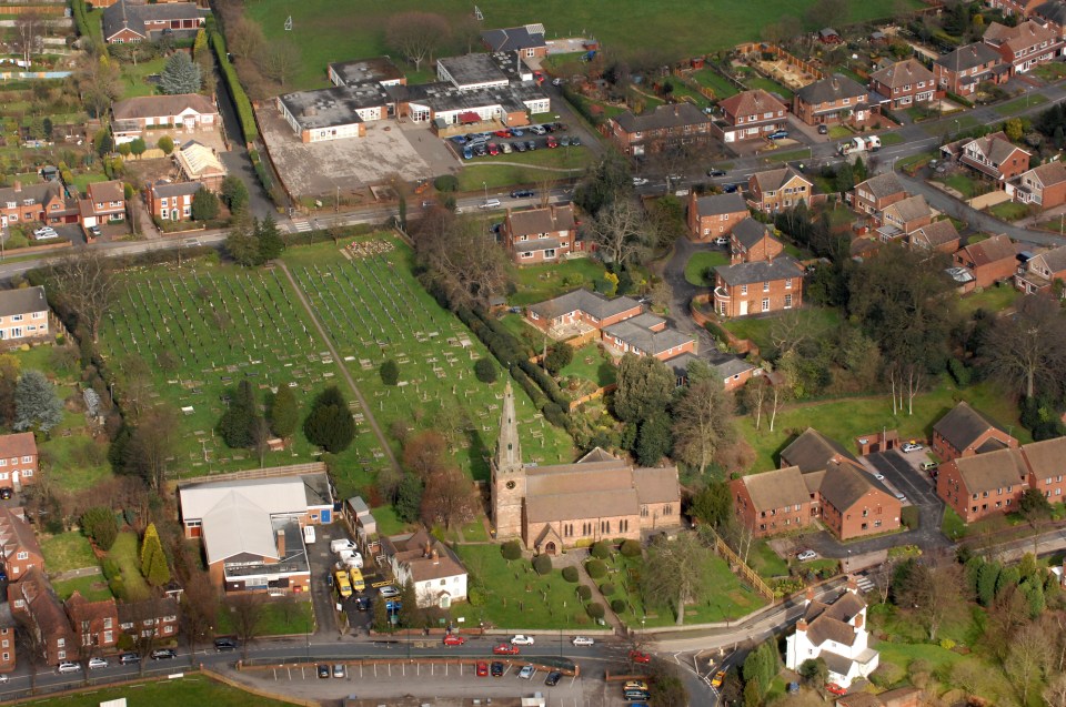 an aerial view of a residential area with a church in the middle