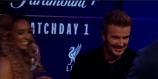 a man and a woman are sitting in front of a sign that says matchday 1