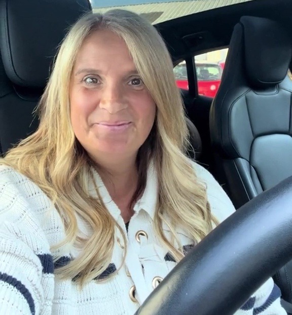 a woman is sitting in the driver 's seat of a car