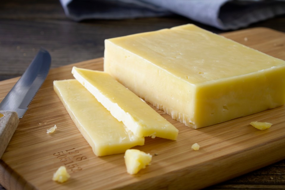a piece of cheese on a cutting board with the year 1861 on it