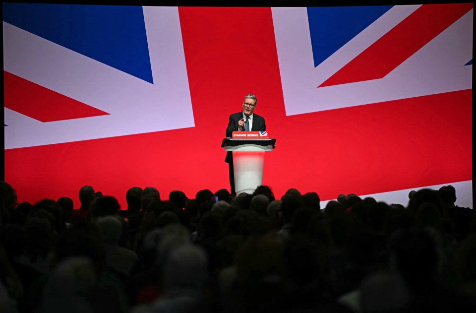 a man stands at a podium with a sign that says ' conservative party ' on it