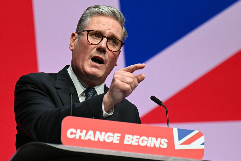 a man speaking at a podium that says change begins