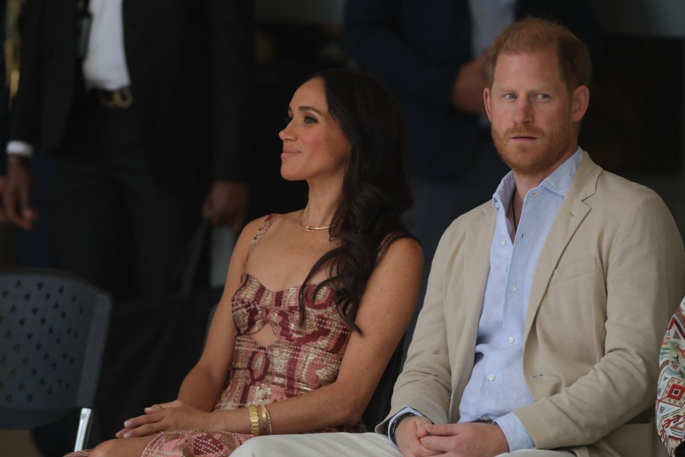 prince harry and meghan markle sit next to each other