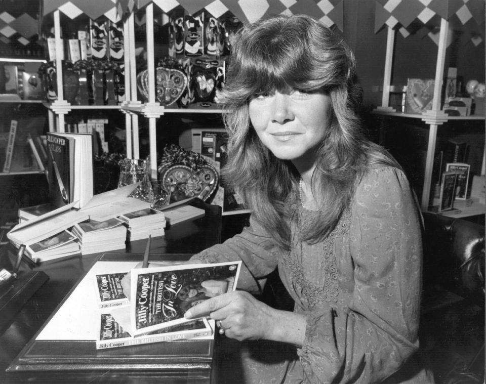 a woman sits at a desk with a book titled " in love "
