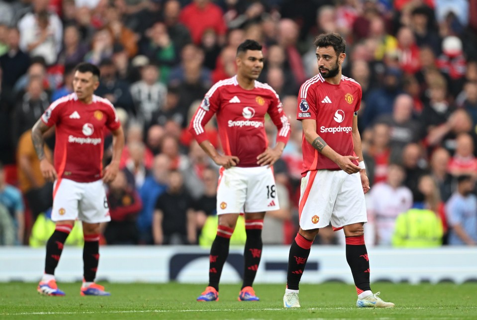 soccer players wearing snapdragon jerseys stand on the field