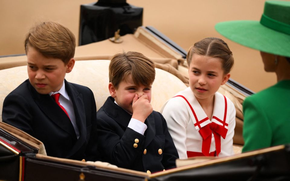 a girl in a green hat sits next to two boys in suits