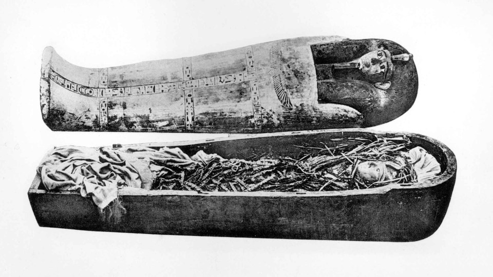 a black and white photo of a coffin with the word egyptian on it