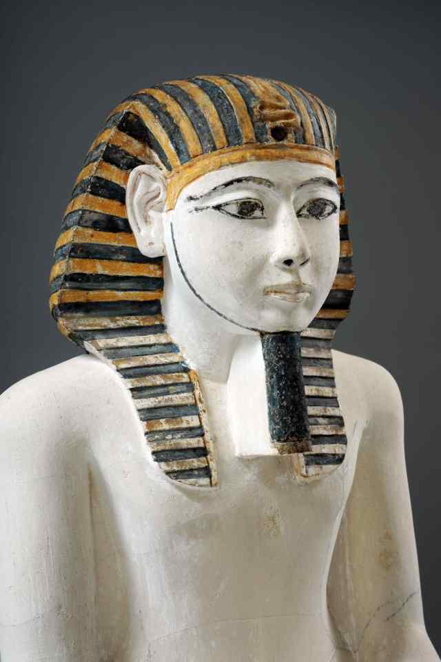 a statue of a man with a striped hat on his head
