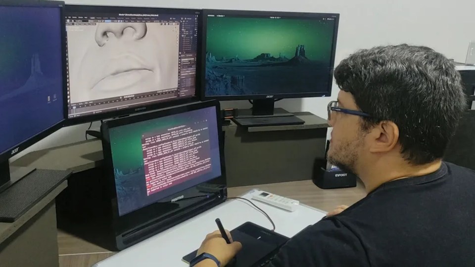 a man sitting in front of an acer computer
