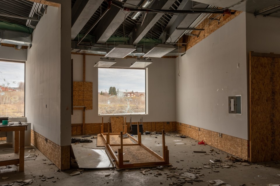 an empty room with a table in the middle of it