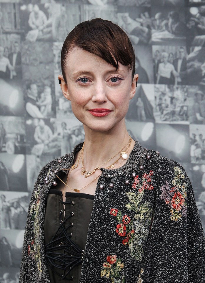 a woman wearing a jacket with flowers on it