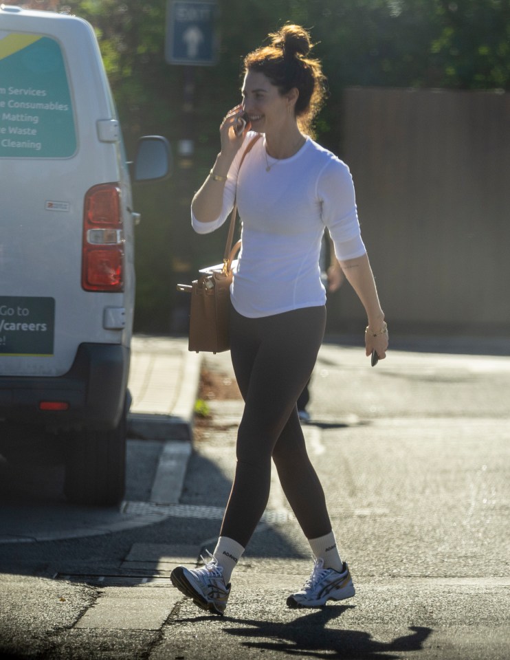 a woman talking on a cell phone in front of a van that says go to careers