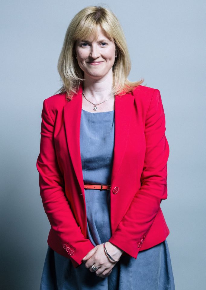 a woman wearing a red jacket and a blue dress