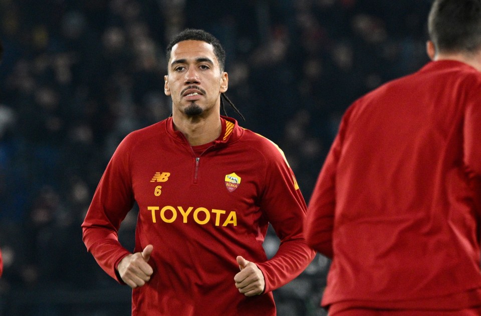 a soccer player wearing a red jersey that says toyota