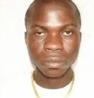 a close up of a man 's face with a necklace around his neck .