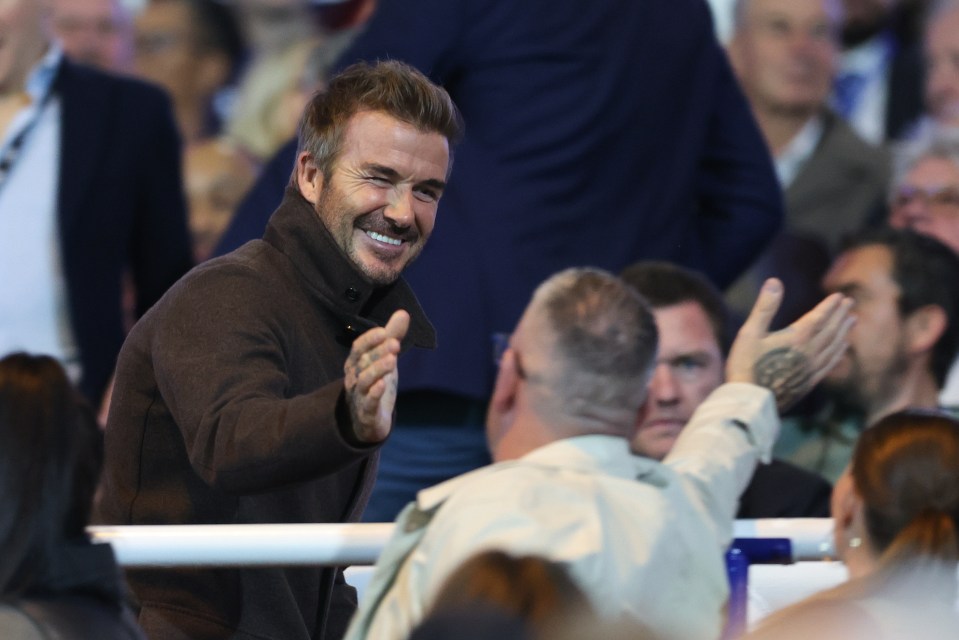 a man giving a high five to another man in a crowd
