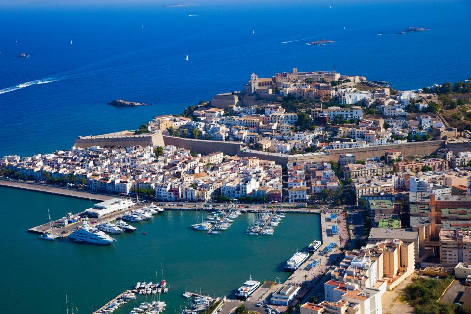 an aerial view of a city with boats in the water