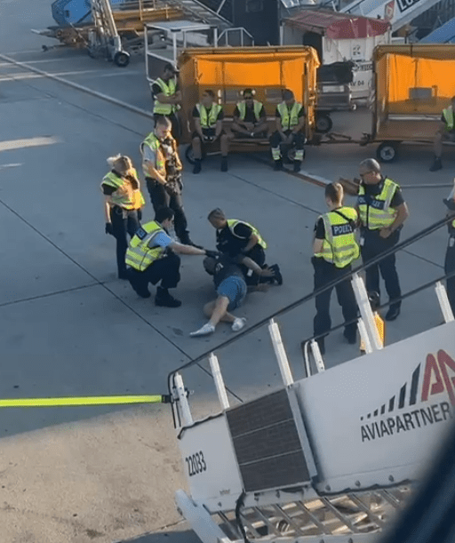 Passengers said he was drinking out of a large bottle of scotch before takeoff