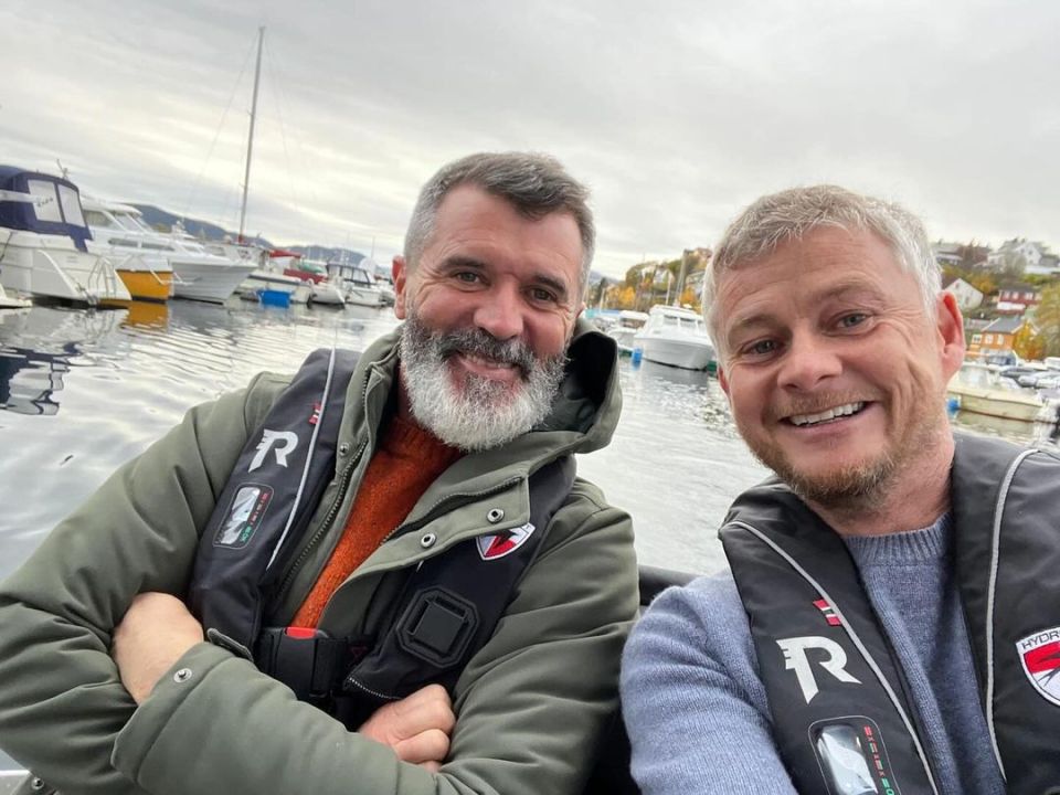 two men wearing life vests with the letter r on them