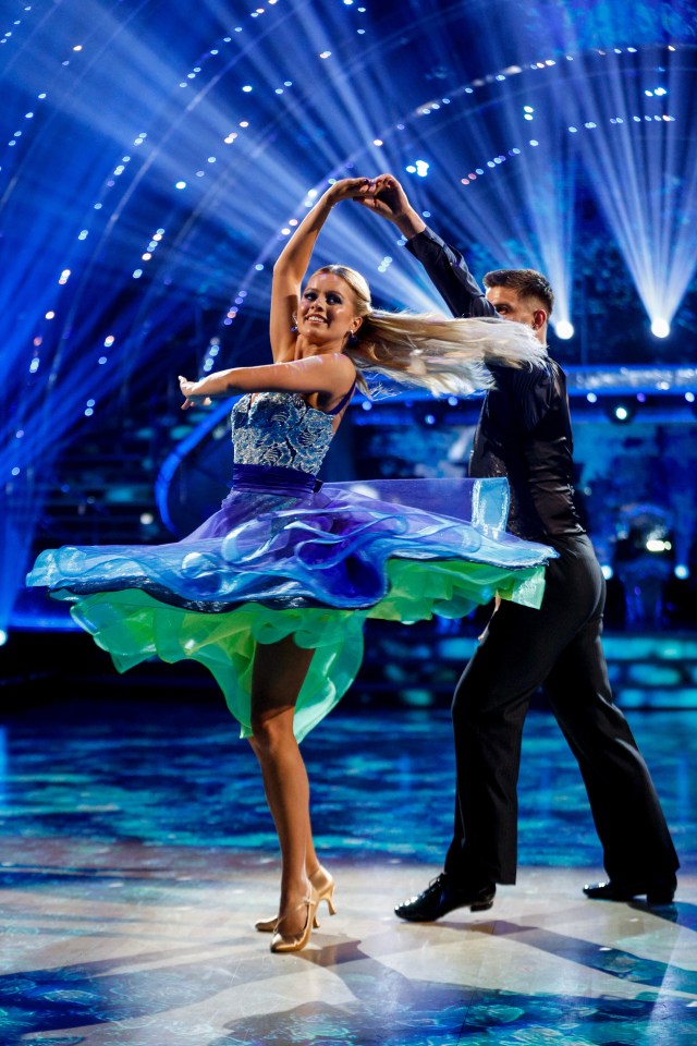 a man and a woman are dancing on a dance floor