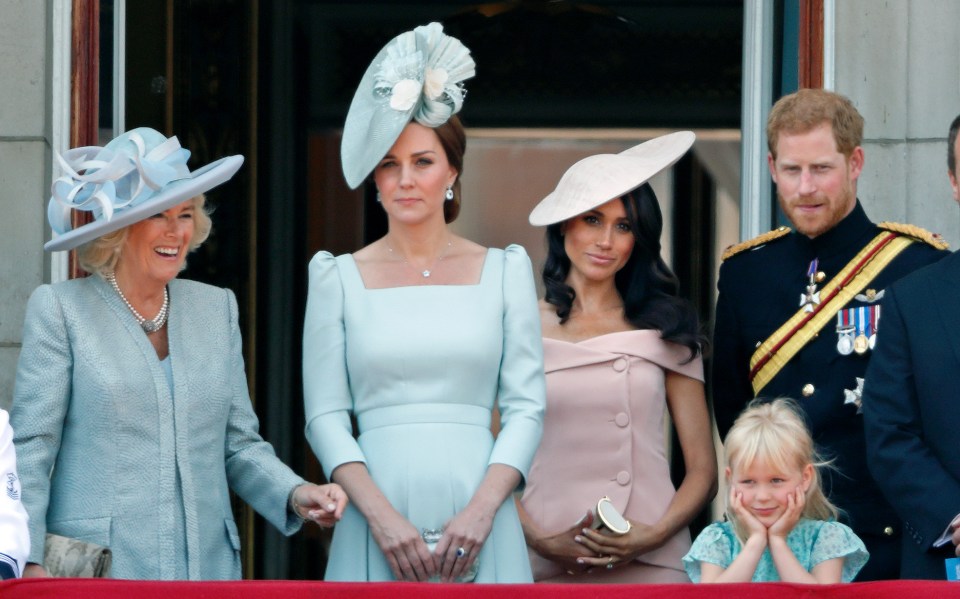 a group of people standing on a balcony including a little girl