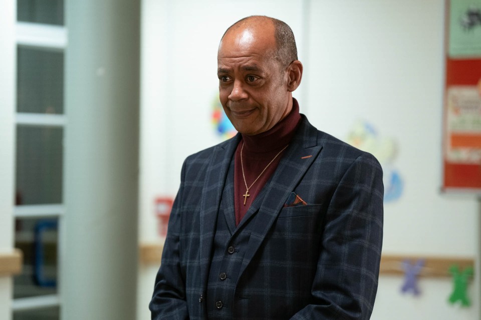 a man in a suit has a cross in his pocket