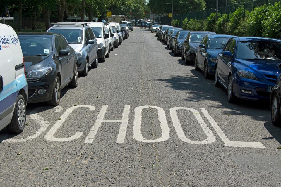 the word school is painted on the side of the road