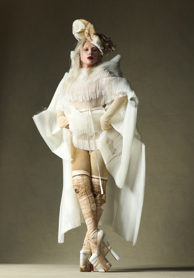 a woman in a white dress with a hat on her head