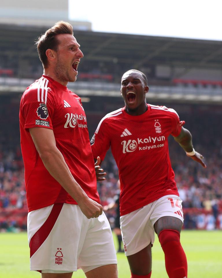 two soccer players wearing kaiyun jerseys are celebrating