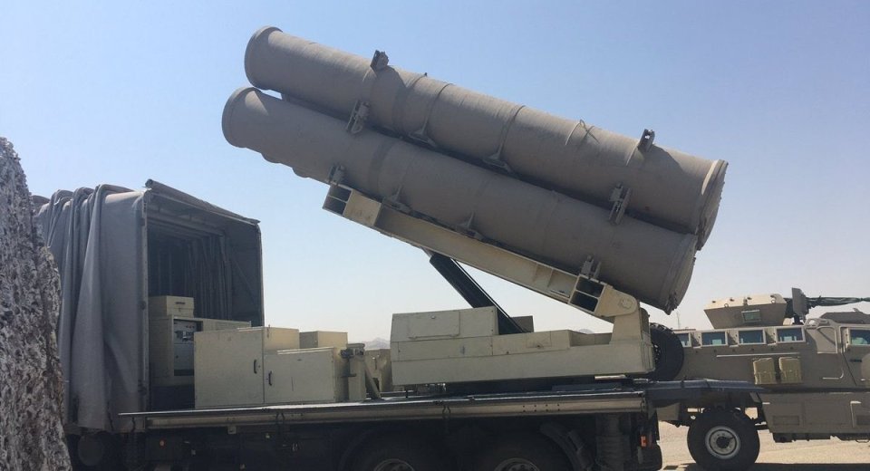a military vehicle with a large cylinder on top of it