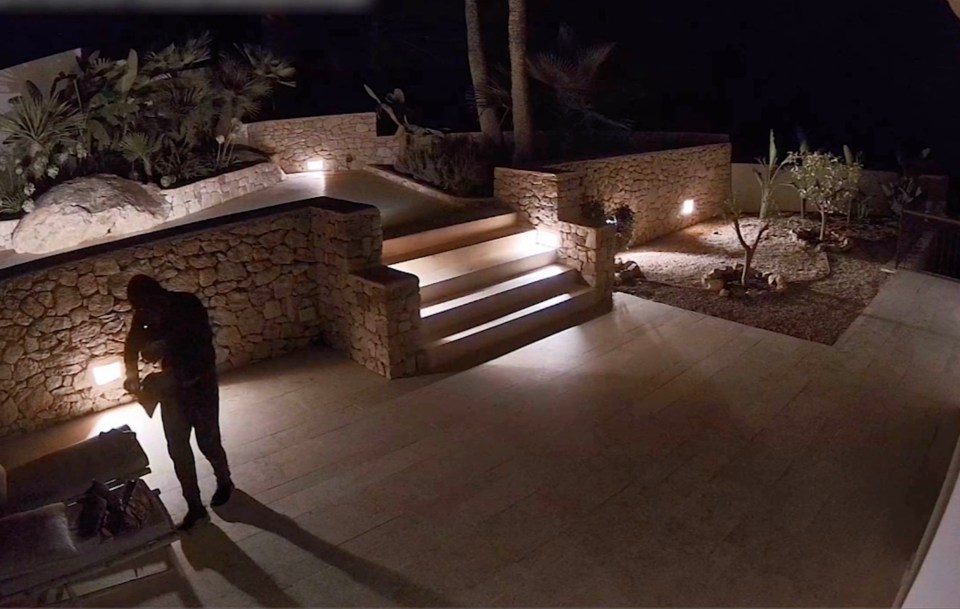 a spx image of a man standing on a patio at night