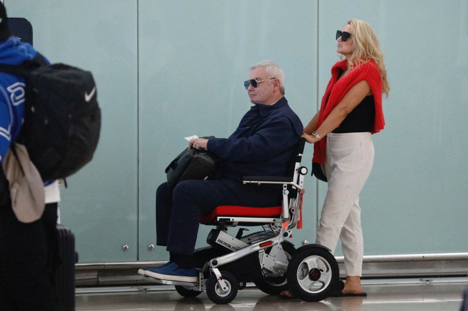 a man in a wheelchair is being pushed by a woman