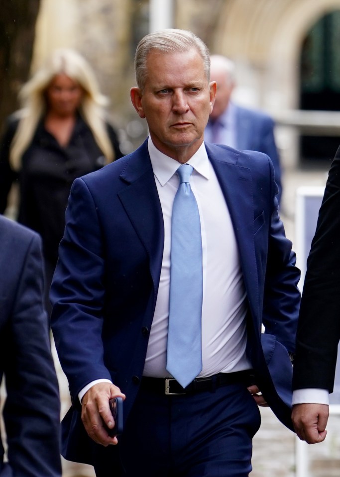 a man in a suit and tie is walking down the street