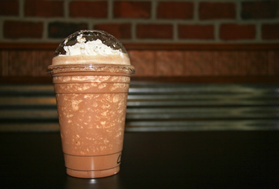 a cup of iced coffee with whipped cream on top