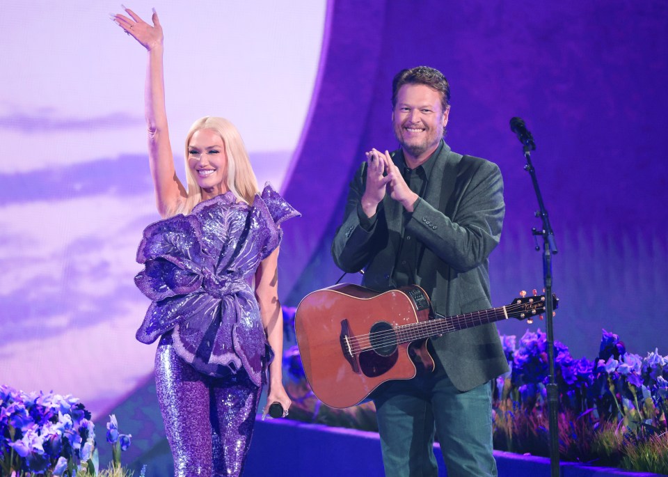 a man playing a guitar next to a woman holding a microphone