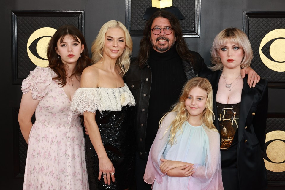 a family posing for a picture on the red carpet