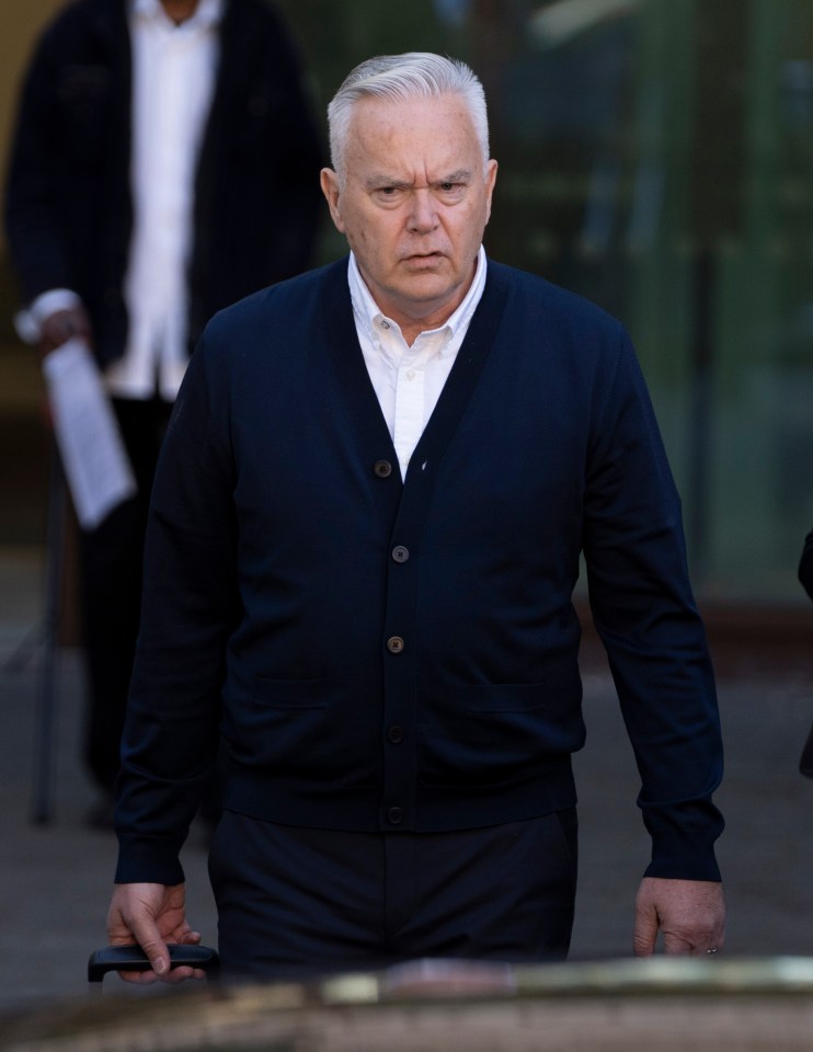 a man wearing a blue cardigan and a white shirt