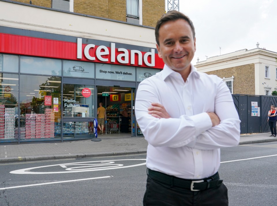 a man stands in front of an iceland store
