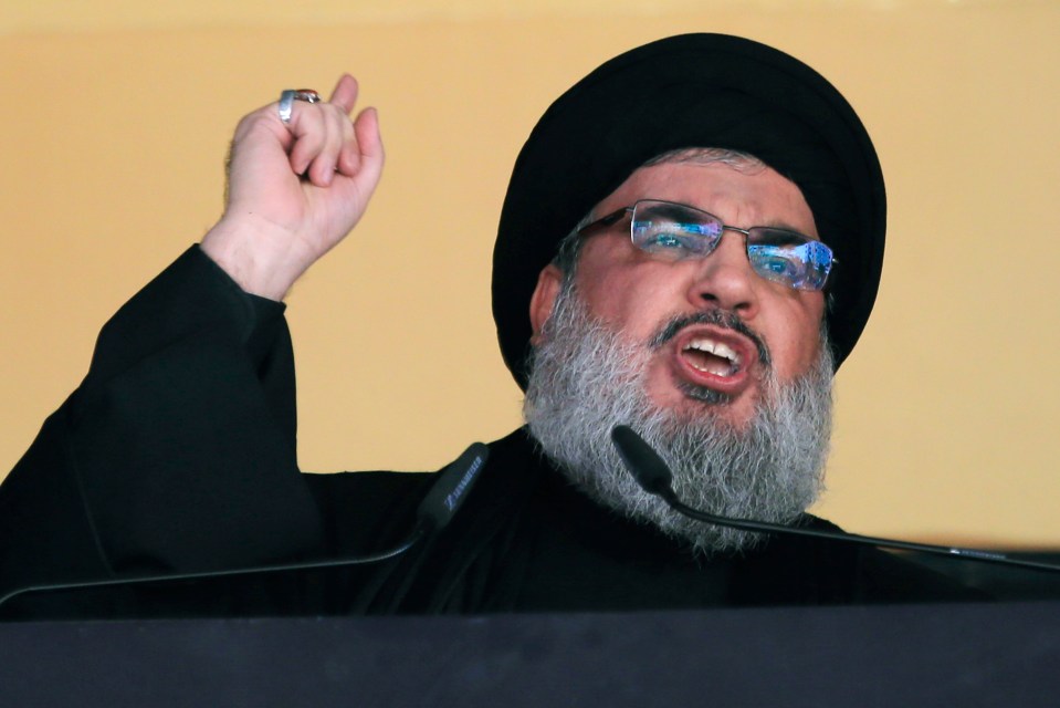 a man with glasses and a beard speaking into a microphone