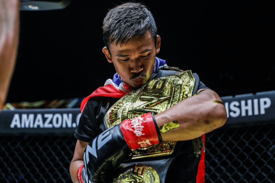 a fighter with a belt that says ufc on it