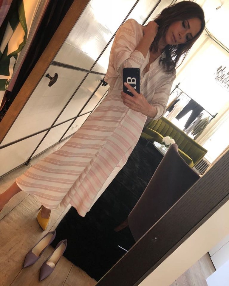 a woman taking a selfie with a phone that has the letter b on it