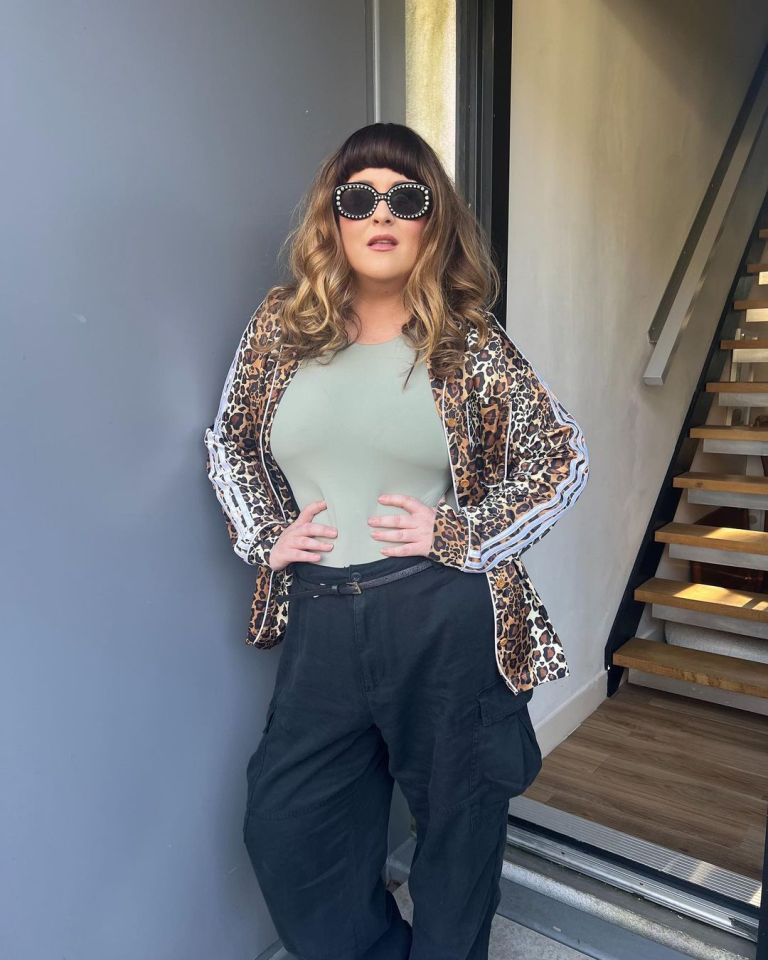 a woman wearing sunglasses and a leopard print jacket