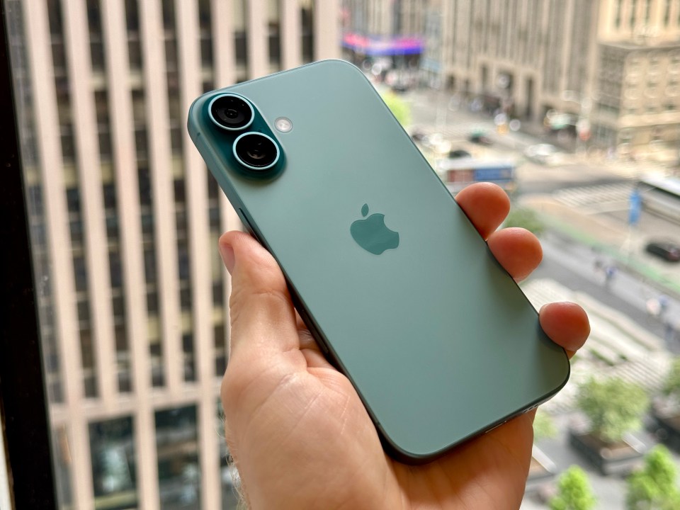 a person is holding a green apple iphone in their hand