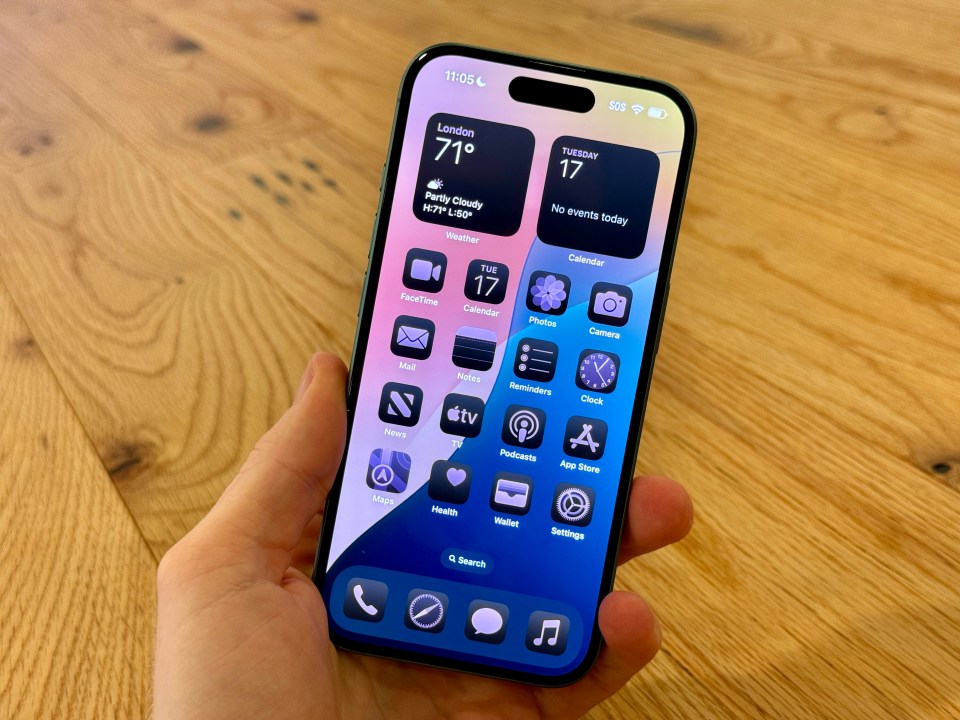 a person is holding a phone that shows the time as 11:05