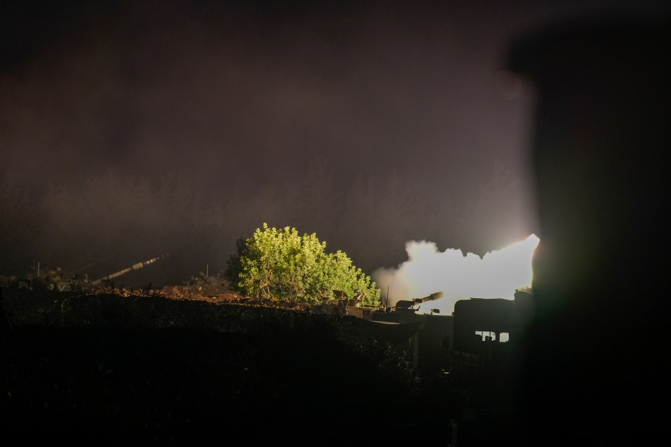 a cannon is being fired at night with smoke coming out of it