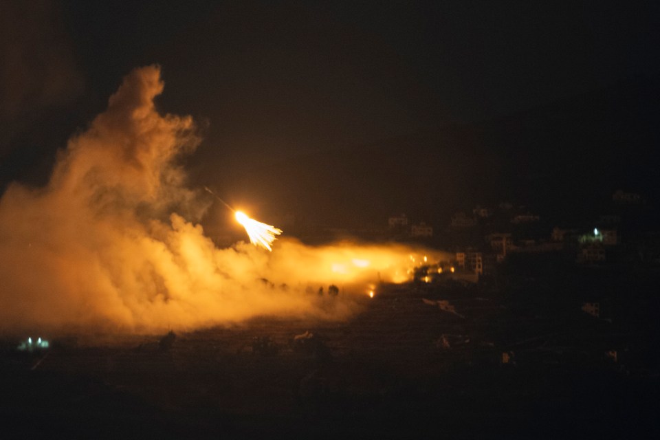 a rocket is being launched into the night sky