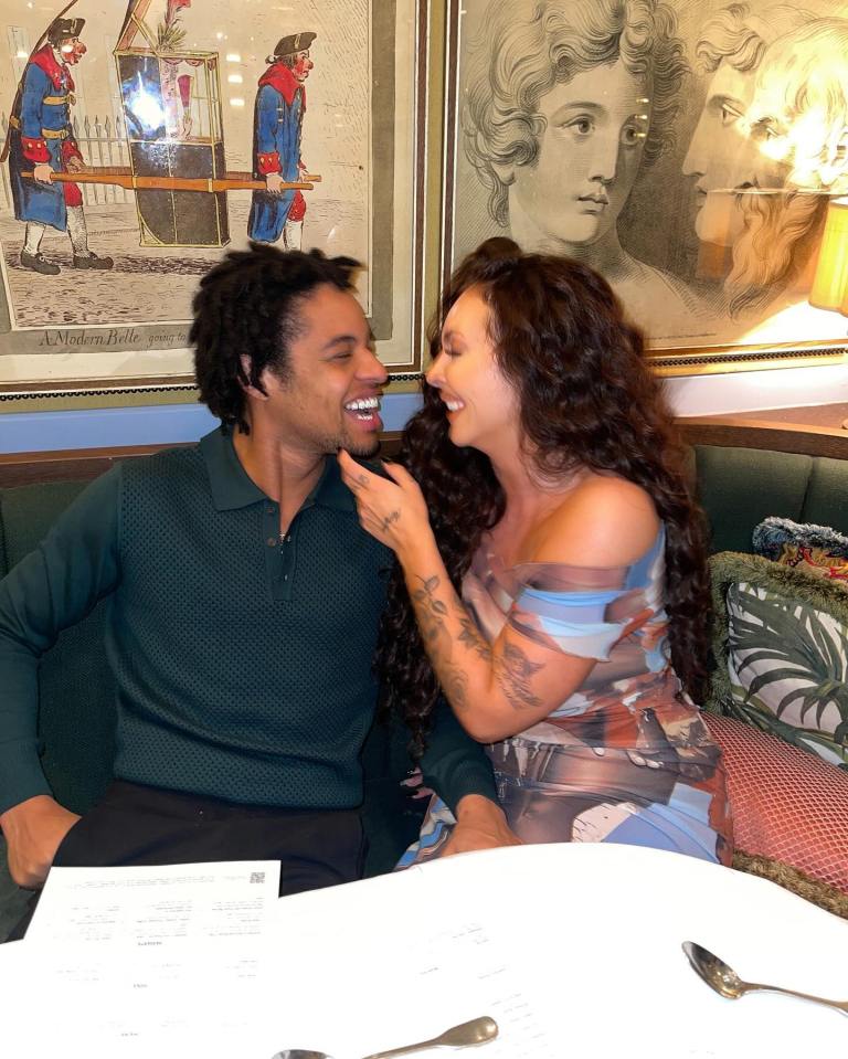 a man and a woman are sitting at a table in front of a picture that says a modern belle