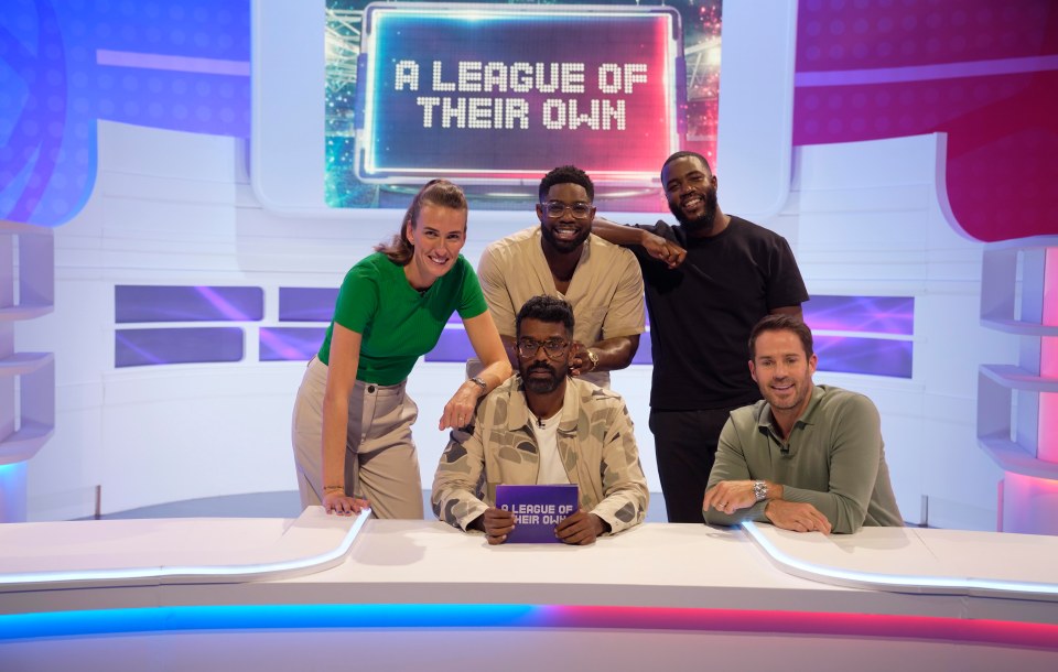 a group of people standing in front of a sign that says a league of their own