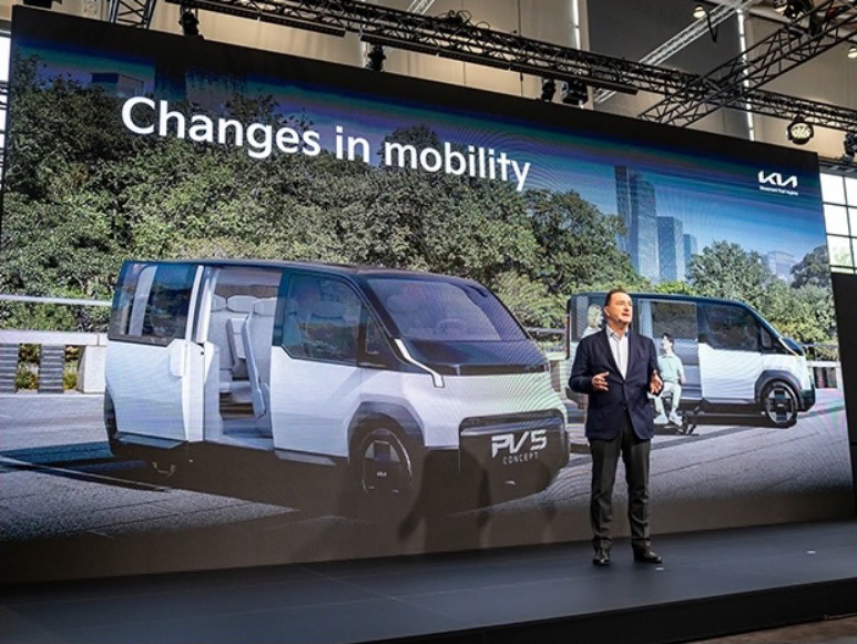 a man stands in front of a large screen that says changes in mobility